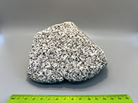 a crystalline rock displaying smal white, gray, and black crystals like salt and pepper